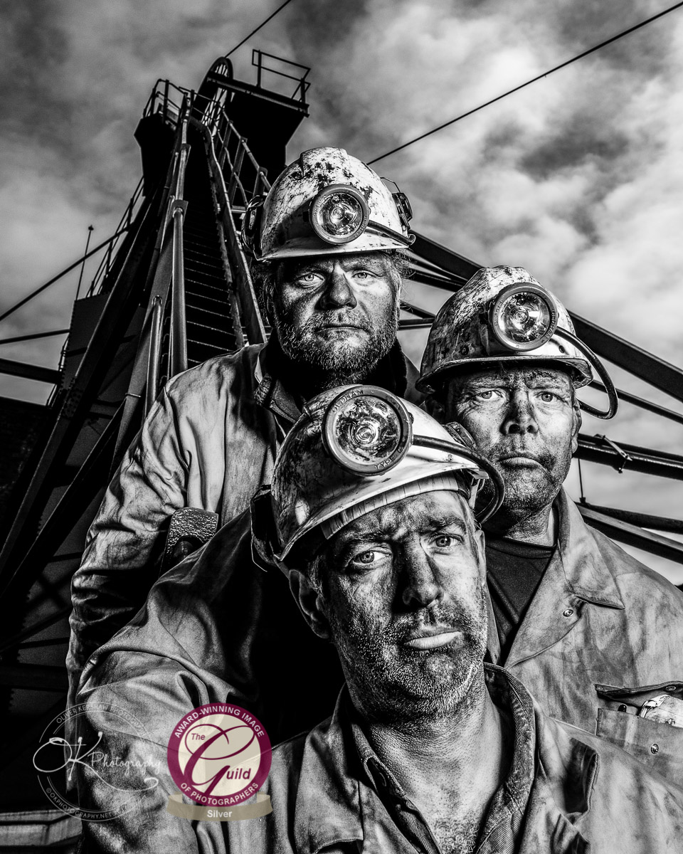 Group of miners standing by the coal