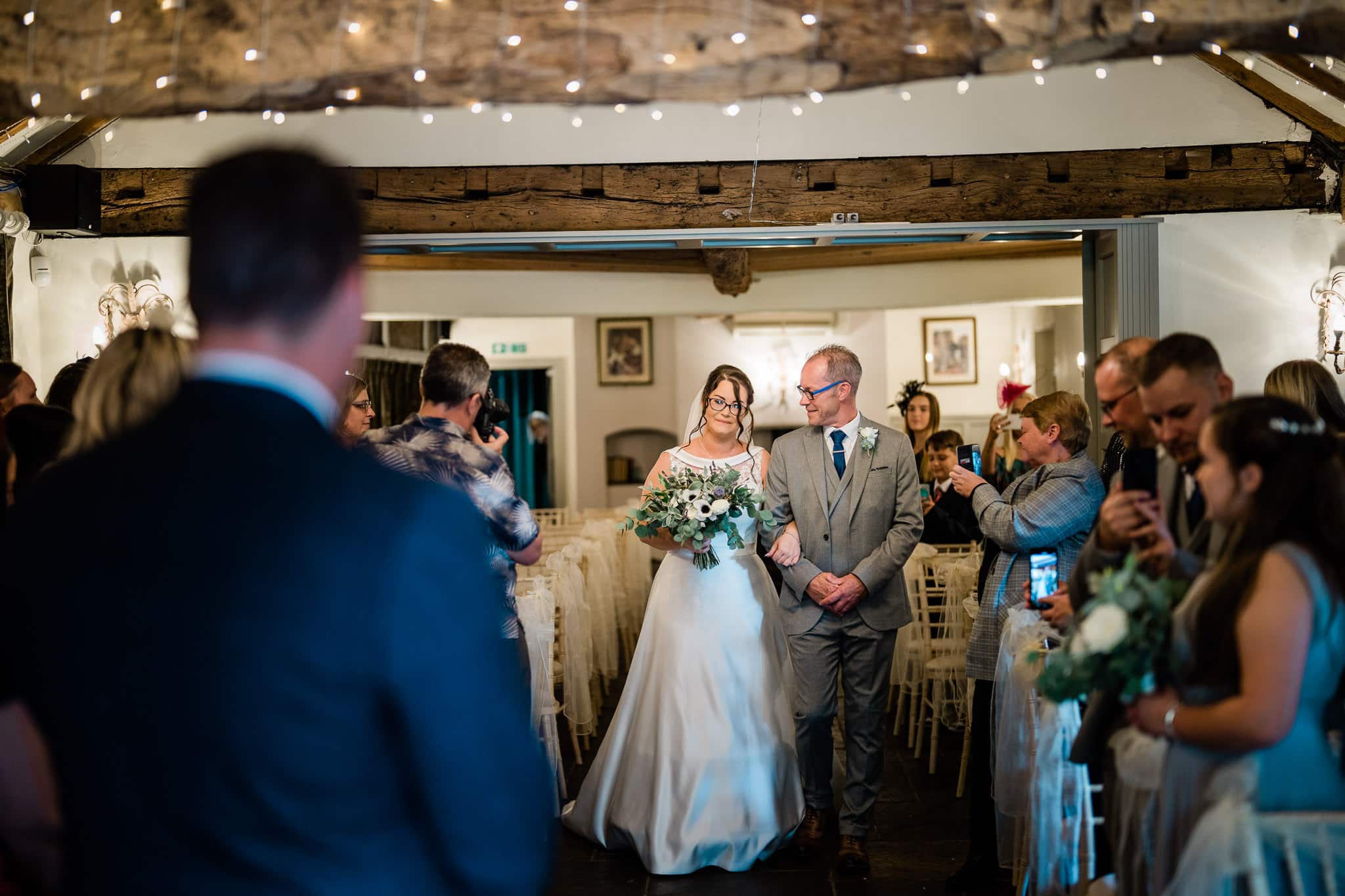 Bride and groom walking down the aisle at Shearsby Bath wedding venue.