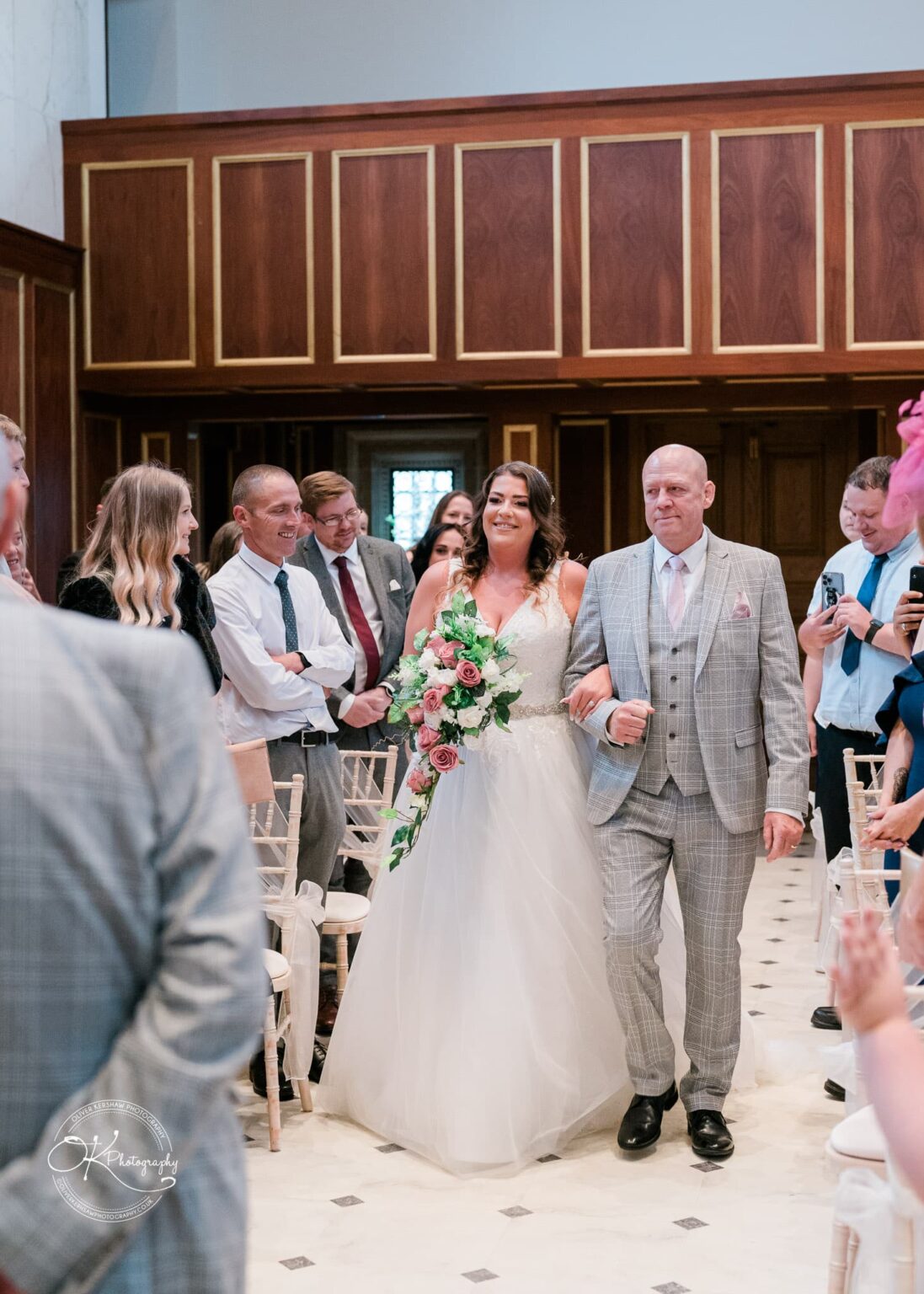 Bride walking down the aisle with her father at Bourton Hall.