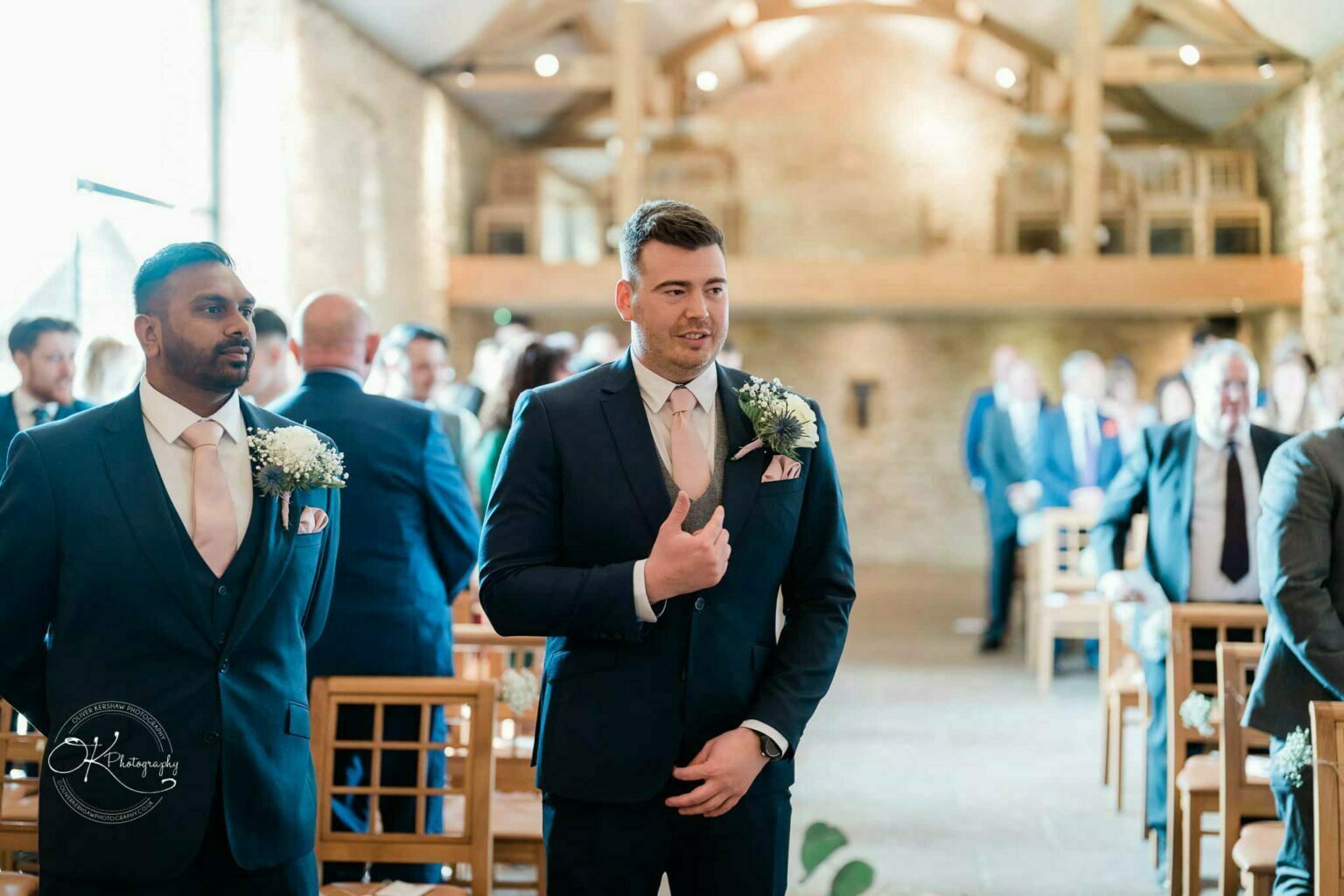 Dodford Manor Barn Wedding Photography Groom and best man waiting at the altar in a rustic barn wedding venue.