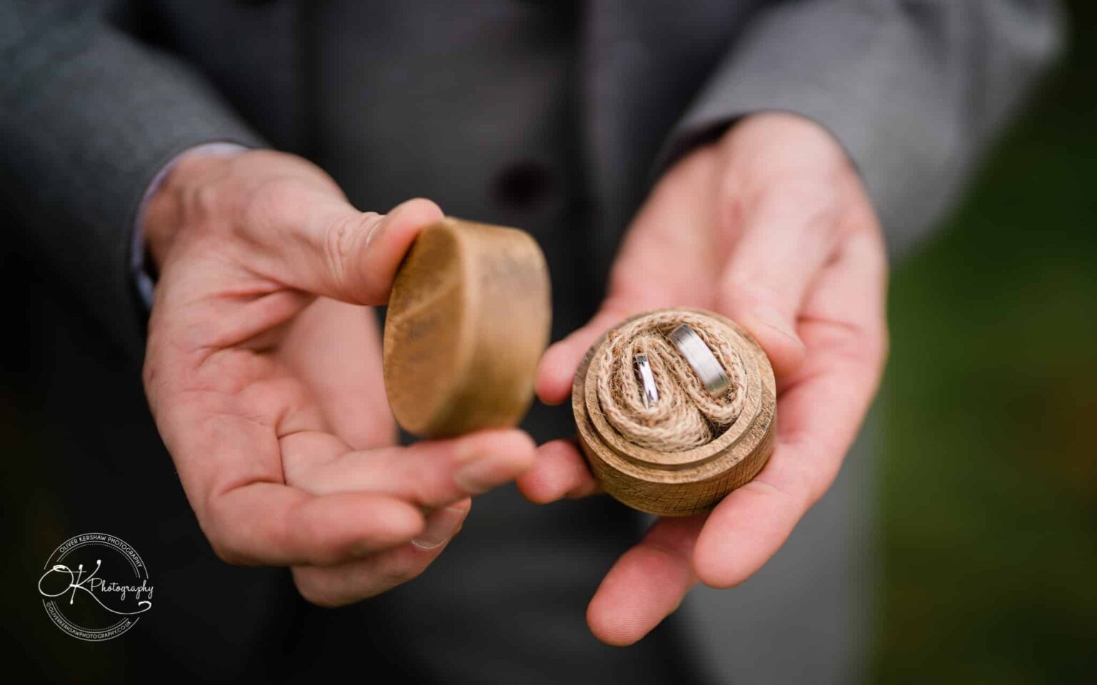 Shearsby Bath Wedding Photography Hands holding a wooden box with two rings inside.
