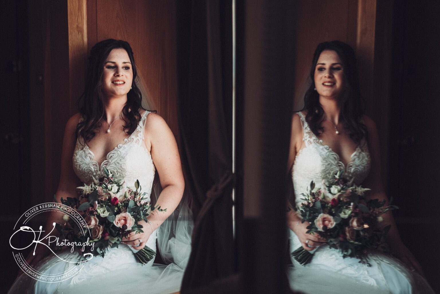 Bride in white lace wedding dress holding bouquet, reflected in a mirror.