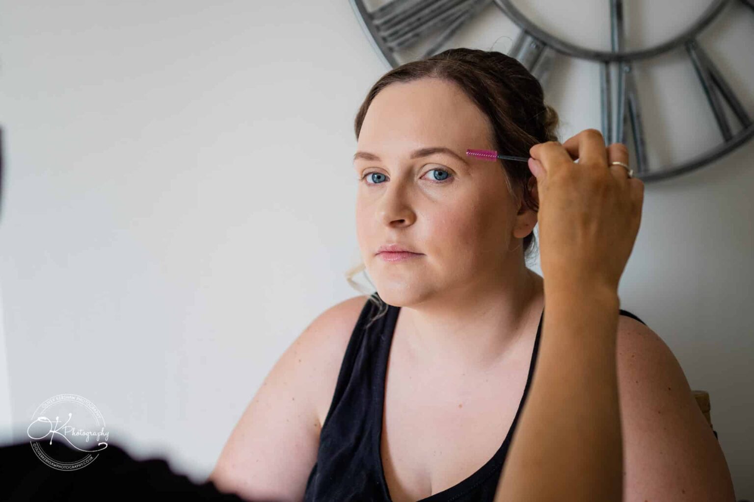 A person having their eyebrows groomed with a brush.