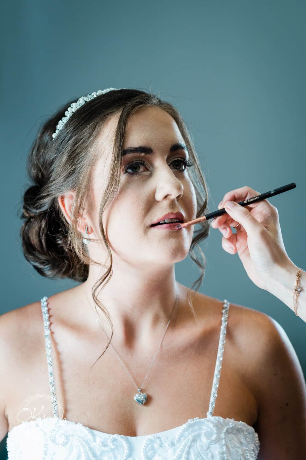 Warwick House Wedding Photography Bride having lipstick applied while preparing for her wedding.