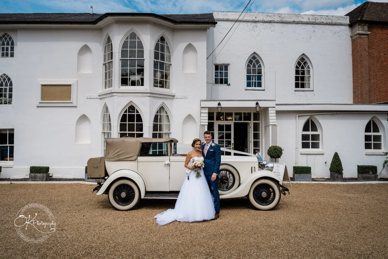 Warwick House Wedding Photography Bride and groom standing in front of a vintage car outside Warwick House.