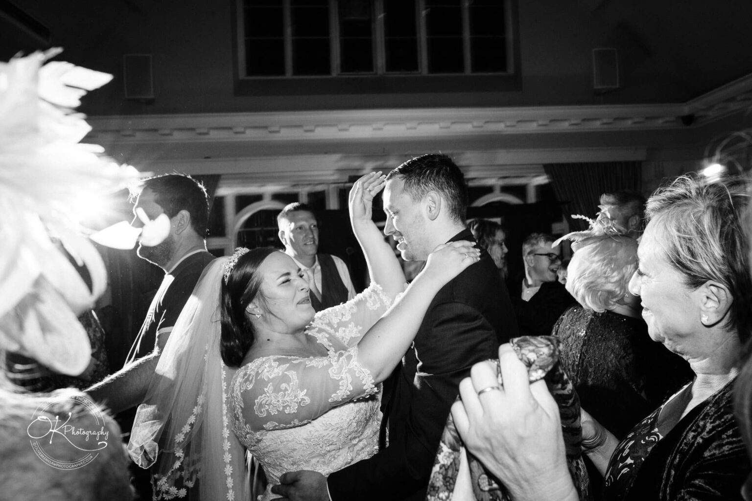 Wedding photography The Embankment A newlywed couple dancing surrounded by guests at a wedding reception.