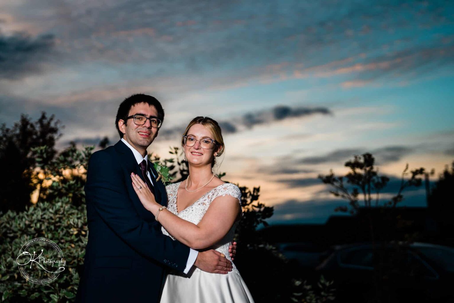 Yew Lodge Hotel Wedding Photography Bride and groom posing outdoors at sunset.