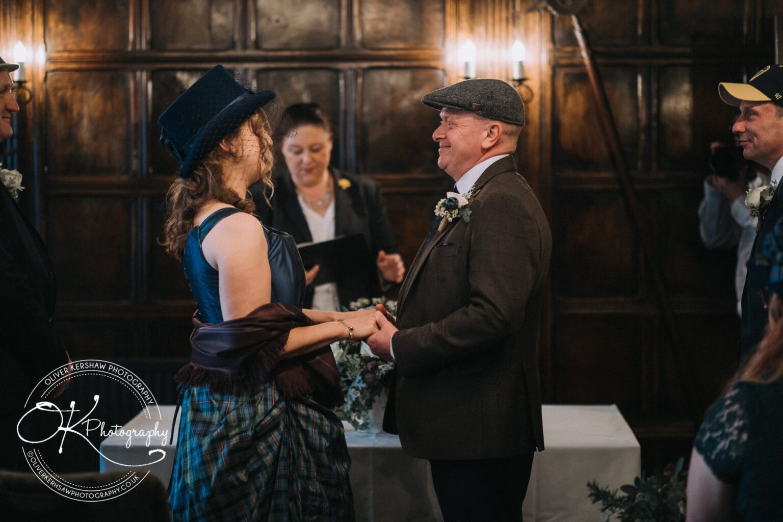 Wedding Photography George Hotel Stamford A couple holding hands and smiling at each other during a wedding ceremony at George Hotel Stamford.