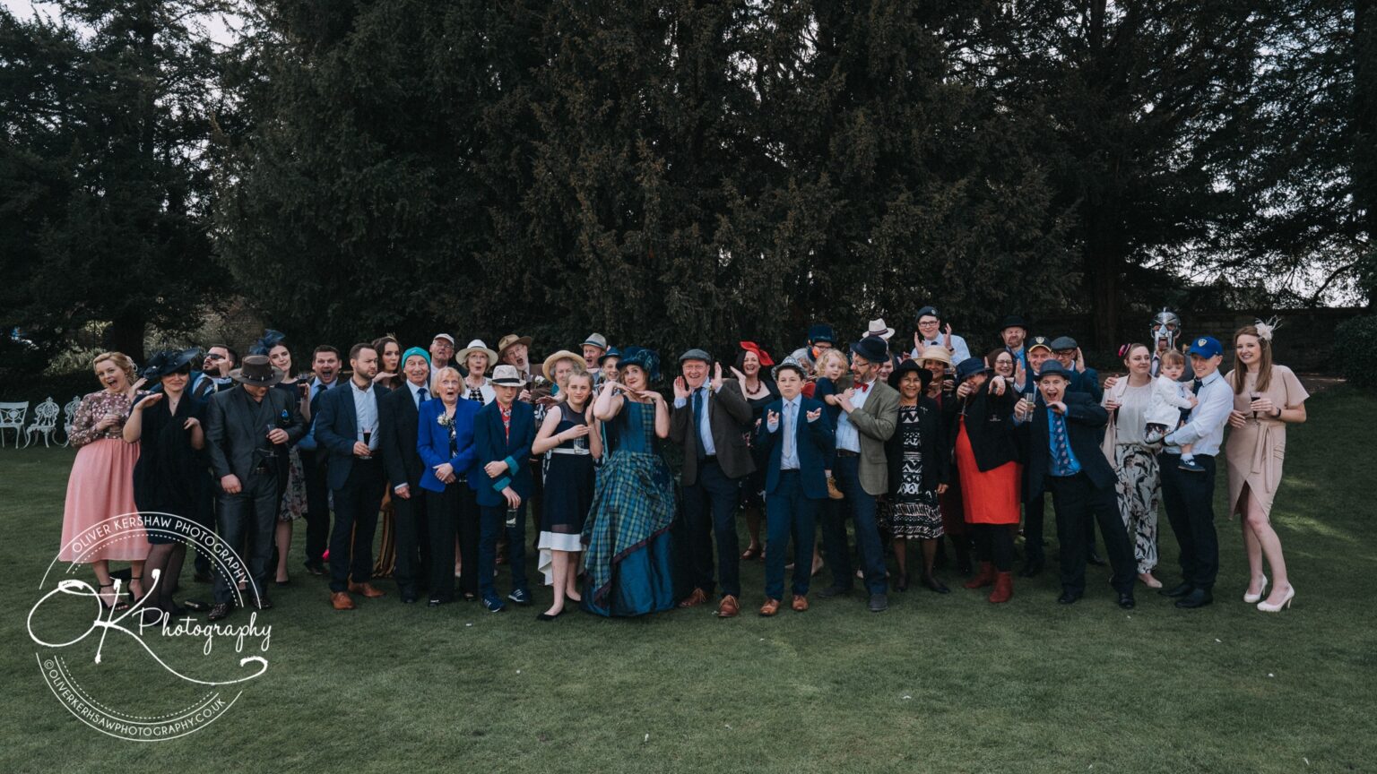 Wedding Photography George Hotel Stamford Group of people in formal attire posing outdoors for a photograph at a gathering.