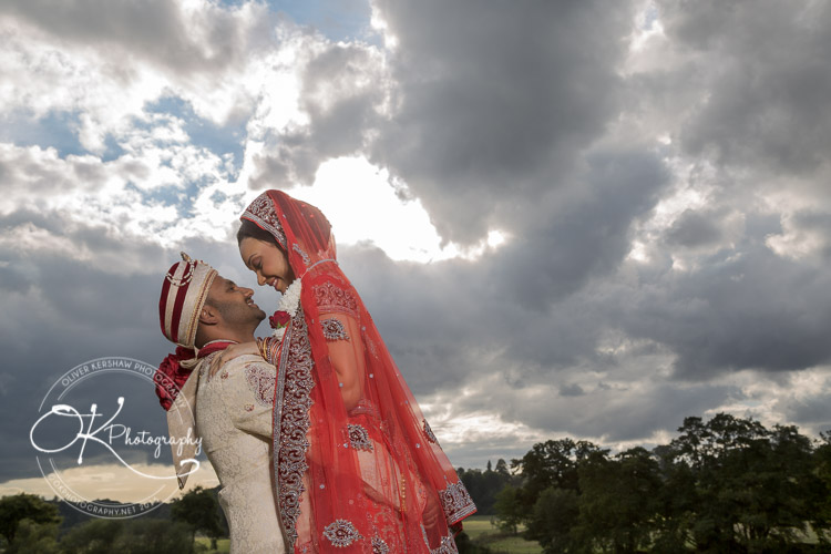 Beautiful photo of bride and groom against the clouds
