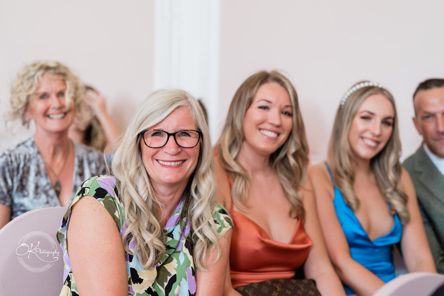 A group of smiling people sitting indoors at Bosworth Hall Hotel.