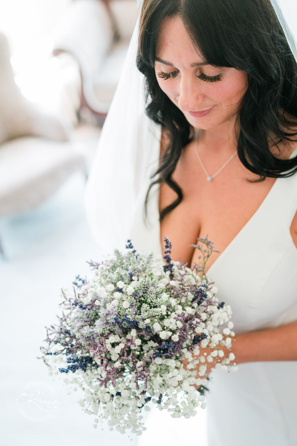 Rothley Court Hotel wedding photography Bride holding a bouquet of small white and purple flowers.