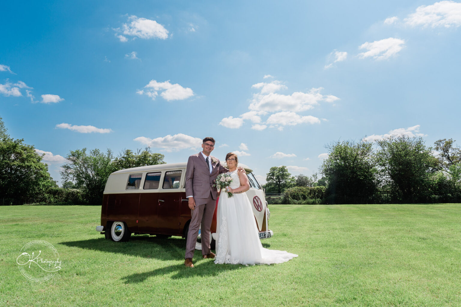 The Old Stables Wedding Photography Bride and groom posing in front of a vintage Volkswagen camper van on a sunny day.