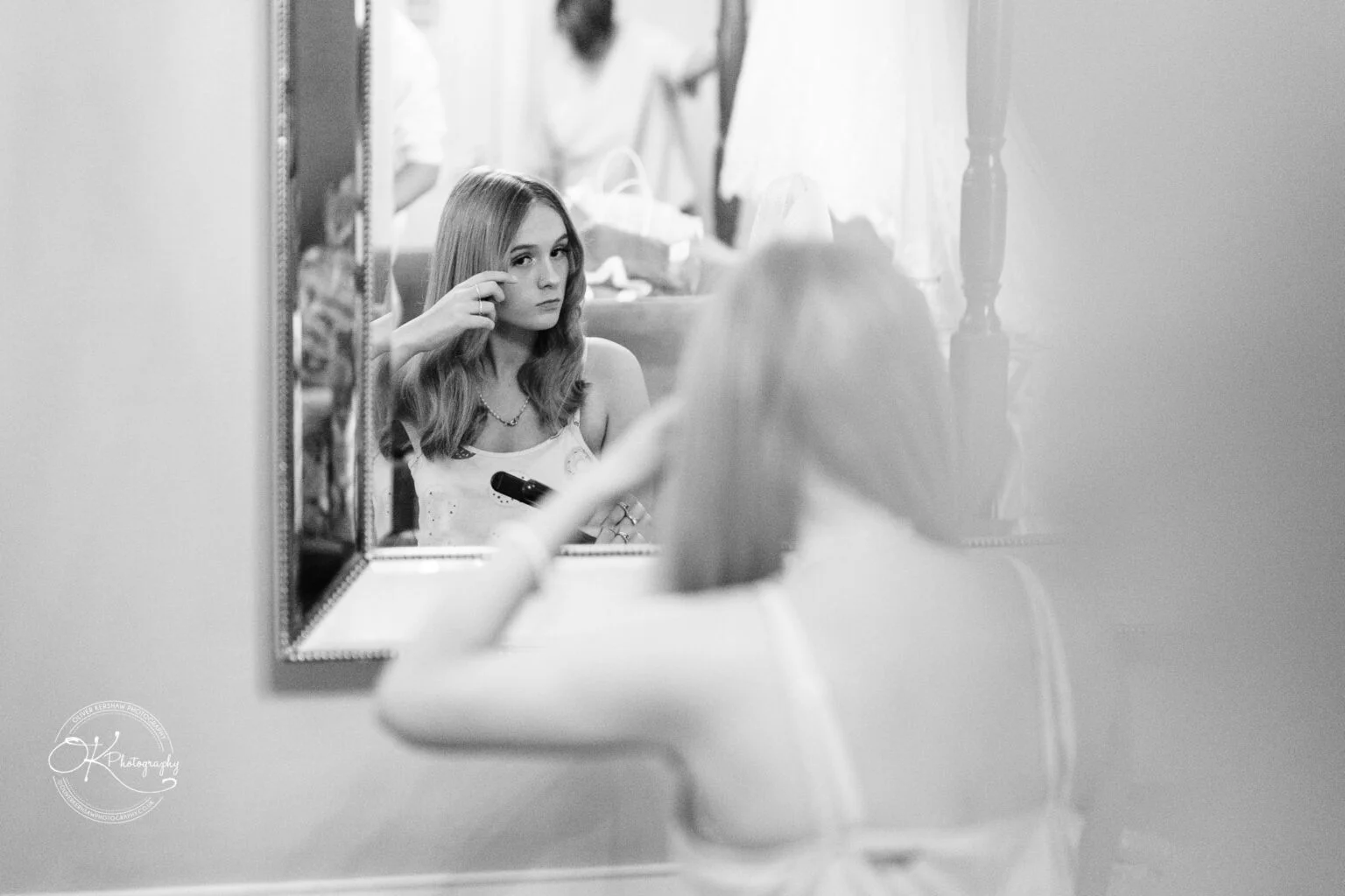 Makeney Hall Hotel - Wedding Photography Black and white image of a woman reflected in a mirror, brushing her hair.