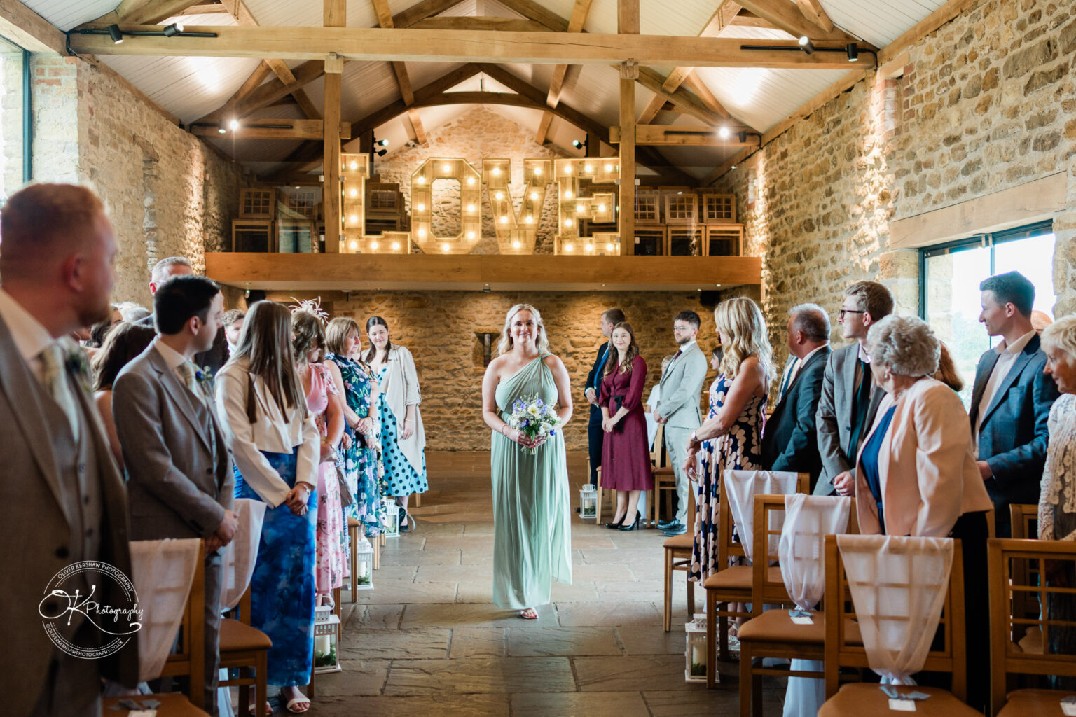 Bridesmaid walking down the aisle at Dodford Manor wedding