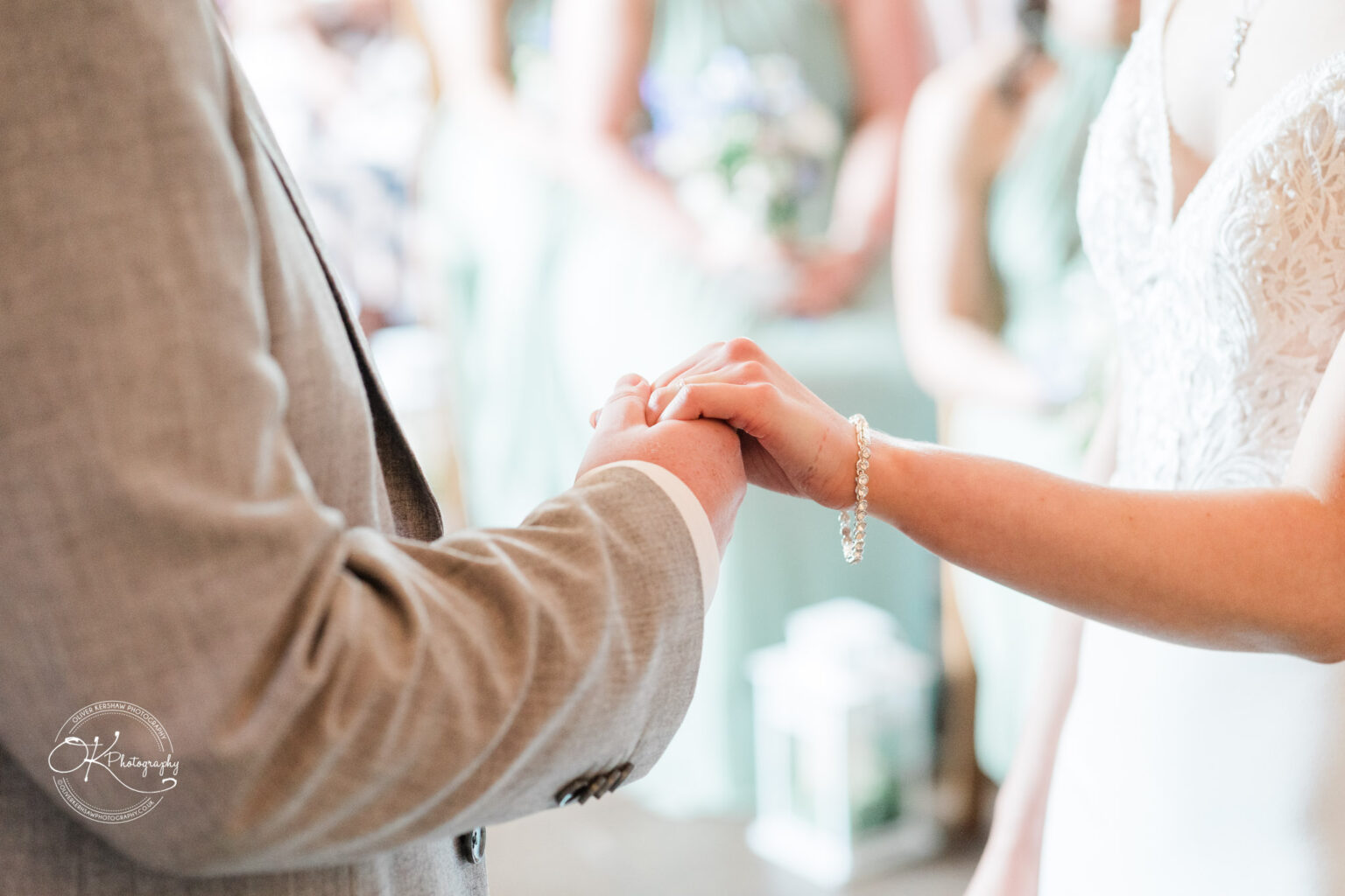 Bride and groom holding hands during ceremony at Dodford Manor