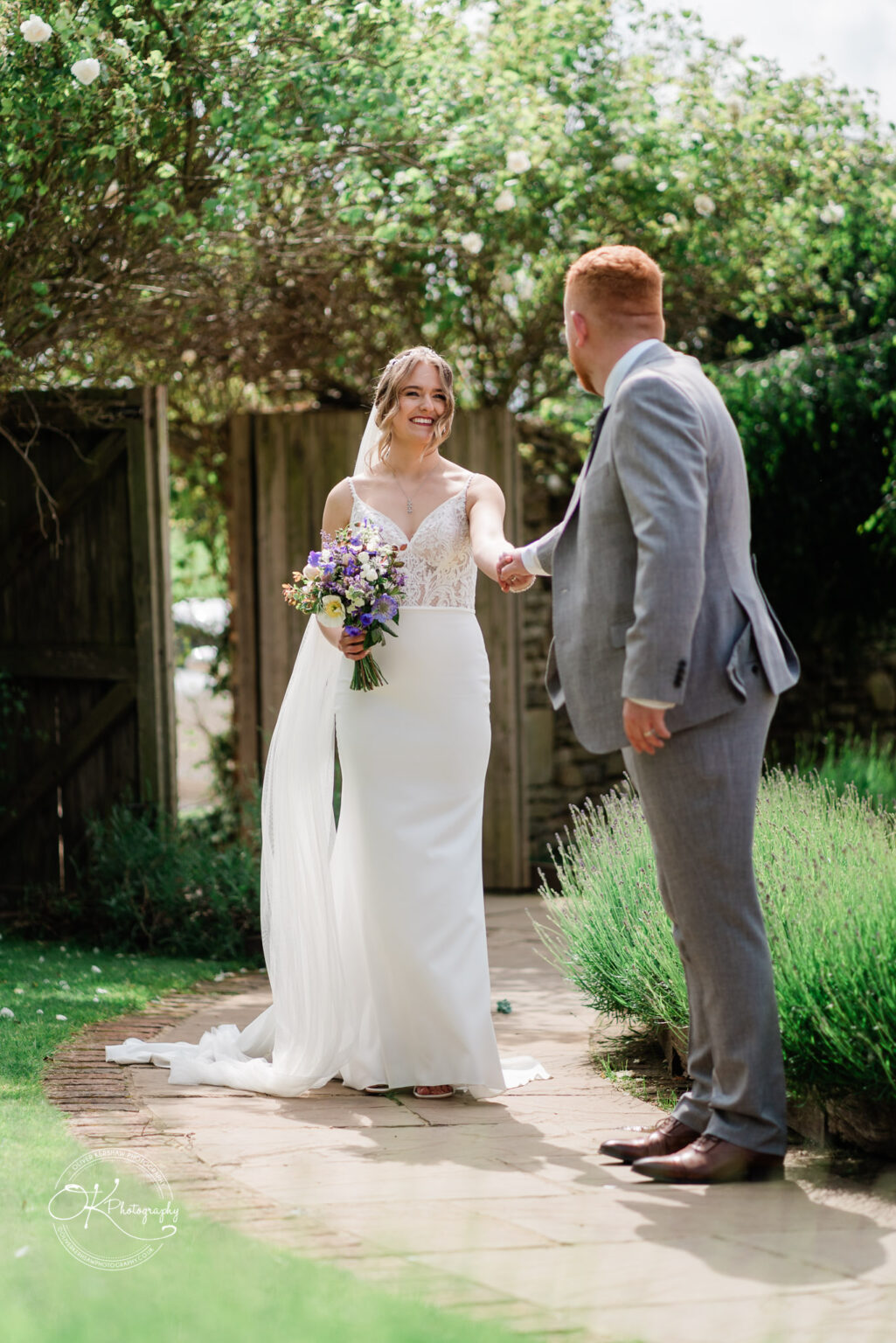 Bride and groom sharing a tender moment in the garden at Dodford Manor
