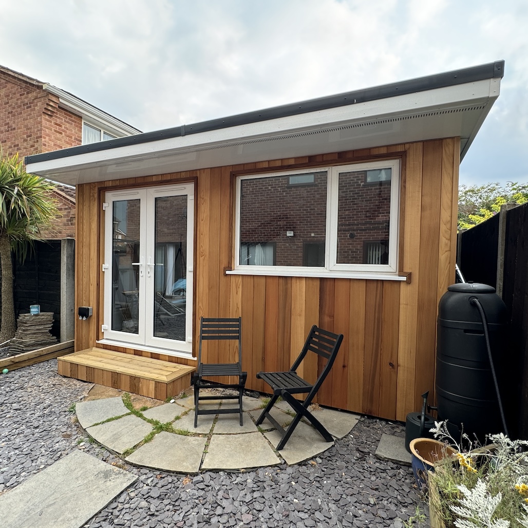 Serene garden studio setting with lush greenery, captured by Oliver Kershaw Photography.