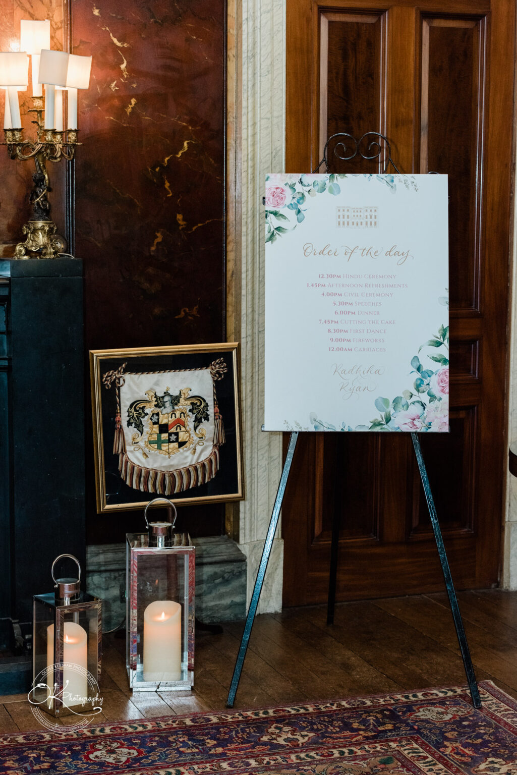 Elegant wedding schedule sign displayed on an easel in a luxurious room.