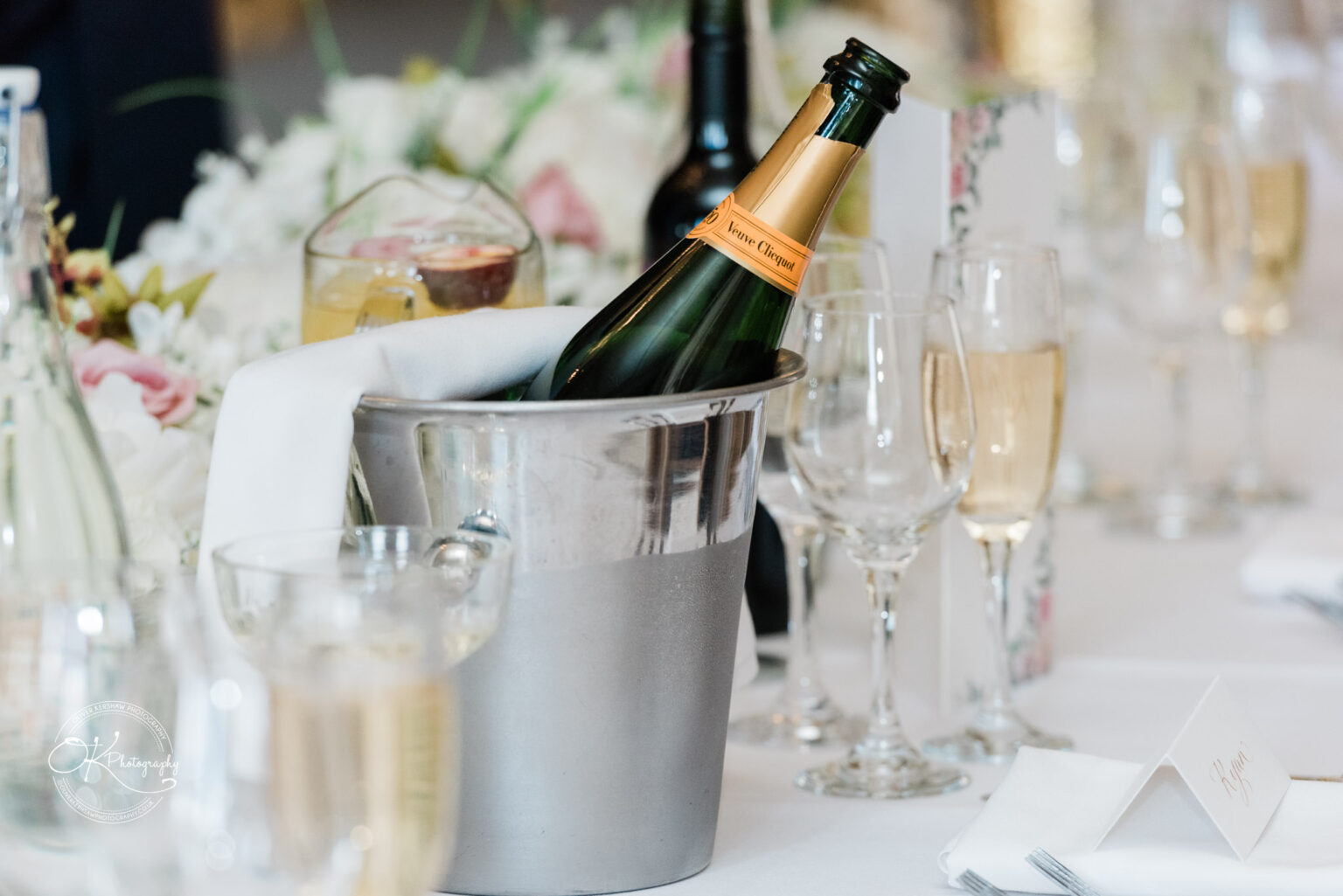 Champagne and glasses on a wedding reception table at Prestwold Hall.