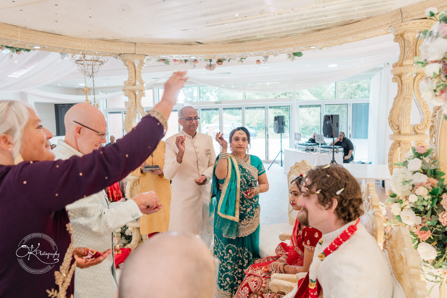 A joyful wedding ceremony at Winstanley House, featuring a couple adorned in traditional attire, surrounded by guests celebrating.